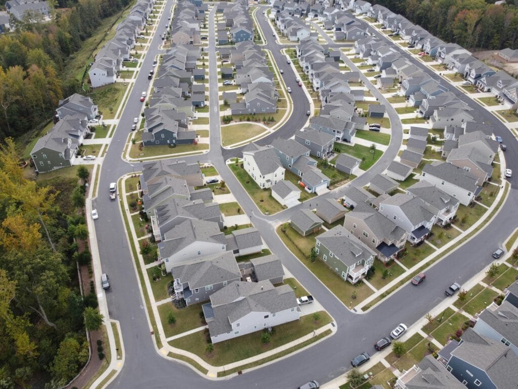Drone shot of a modern residential area with houses and winding roads in Fort Mill, SC.