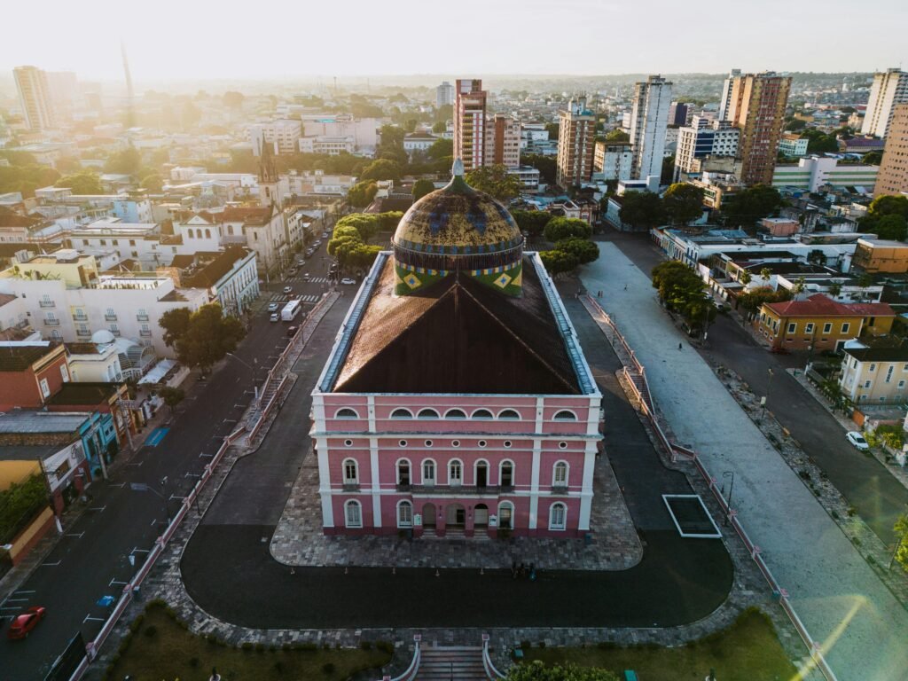 pexels-photo-17291236-17291236 Aerial view of the iconic Teatro Amazonas in Manaus, Brazil, bathed in warm sunset light.